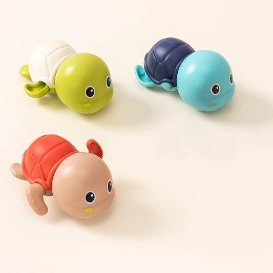 Three colorful wind‑up turtle bath toys in green, blue & pink
